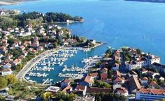 an aerial view of a city with boats in the water