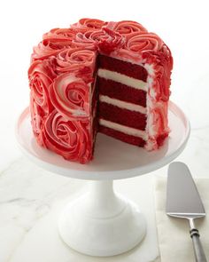 a red velvet cake with white frosting and roses