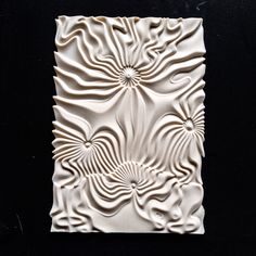 an intricately designed white tile on a black background