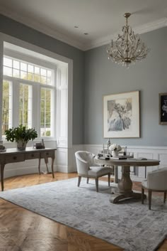 an elegant dining room with gray walls and white trim