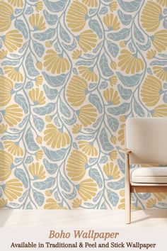 a white chair sitting in front of a wallpapered with blue and yellow leaves