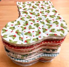 a stack of cloths sitting on top of a wooden table next to each other