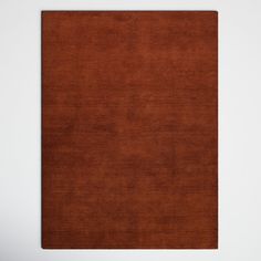 a brown area rug on a white wall