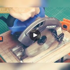 a person using a circular saw to cut wood with an electric tool on a table