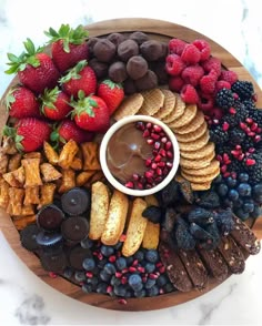 a wooden platter filled with fruit and snacks