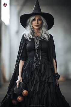 an older woman in a black dress and witch hat