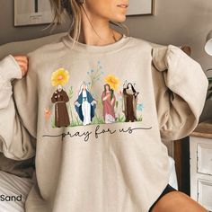 Looking for Catholic Saints Sweatshirt for women Catholic Gifts Catholic Sweatshirt Marian Cross Floral Women Religious Shirts Religious sweatshirt ? You're in the right Place.  This Floral Saint  Sweatshirt Makes a perfect Gift For Her . SIZING GUIDELINES Our sweatshirts are true to size, for an oversized look , we recommend 2 sizes up. HOW TO ORDER OUR  SWEATSHIRTS, 1 ) Please, check and review all photos for size & Shirt details Catholic Shirts, Catholic Clothing, Catholic Shirt, Saints Shirts, Saints Days, All Saints Day, Religious Shirt, Sweatshirt For Women, Jesus Art