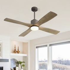 a ceiling fan in a living room next to a window