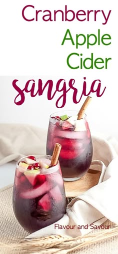 two glasses filled with cranberry apple cider sangria on top of a table