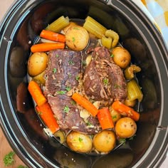 a pot roast with carrots, potatoes and parsley in the slow cooker