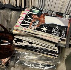 there are many magazines stacked on top of each other