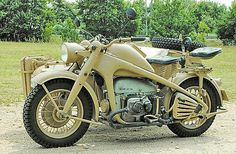 an old motorcycle is parked in the dirt