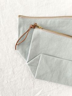 A handmade zipper pouch in 100% linen. The wide gusset at the bottom gives it structure to stand up, while keeping your little items together. So perky. With a brass zipper and a leather pull. Machine wash gentle, dry cool or hang dry 6.25"w x 4.25"h x 2.25" bottom gusset Leather Zipper Pouch, Linen Pouch, Hanging Dryer, Leather Pulls, Leather Zipper, Zipper Pouch, Stand Up, Pouch, Packaging