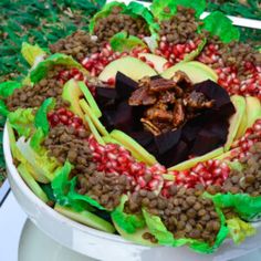 an elaborately decorated cake with chocolates and nuts in the shape of a heart