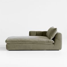 a couch that is sitting in front of a white wall