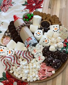 a platter filled with marshmallows, pretzels, and other holiday treats