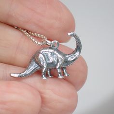 This 3D sterling silver brontosaurus dinosaur charm works great as a necklace or on a charm bracelet. 17mm long including jump ring 25mm wide We recommend a 1mm chain which is sold separately here. Product highlights: Made from 925 sterling silver. Comes in a black cotton filled jewelry box making it easy for gifting. Long Lasting & Worry Free. This item is solid sterling silver and is not plated or filled. Wear it in the shower, at the beach or wherever you go. Tooth Icon, Dinosaur Jewelry, Ring Icon, Chevron Earrings, Chevron Bracelet, Jewellery Box Making, Sagittarius And Capricorn, Chevron Ring, Taurus And Gemini