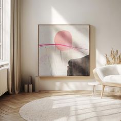 an abstract painting hangs on the wall above a white chair