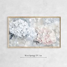 a white and pink floral painting hanging on a wall