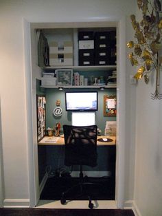 an office with a desk and computer in the doorway to another room that is open