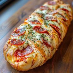 a pepperoni and cheese bread on a wooden table