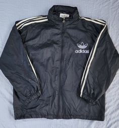 Vintage 1990s Adidas Black White Mesh Lined Tuck Away Hood Trefoil Windbreaker In great condition  Light normal staining white stripes Medium  Also fits a slim Large 28.5 x 26.5 Pit to Pit  Any questions feel free to reach out! Trashy 2000s, 2000s Adidas, Adidas Camo, Jacket Adidas, Adidas Windbreaker, Adidas Vintage, Sun Valley, Camo Jacket, White Mesh