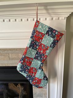 a christmas stocking hanging from a fireplace