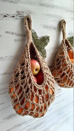 two bags filled with apples sitting on top of a table