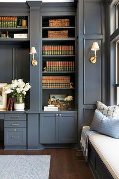 a living room filled with furniture and bookshelves covered in lots of bookcases