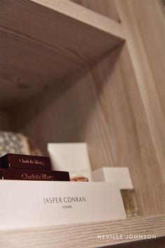 a wooden shelf with business cards on it