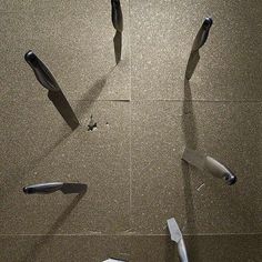 several different tools are laying on the floor with one broken toothbrush and another missing