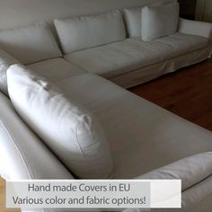 a white couch sitting on top of a hard wood floor