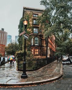 people are walking down the street with umbrellas on a rainy day in new york city