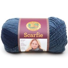 the yarn is blue and has a brown label on it that says scarfie