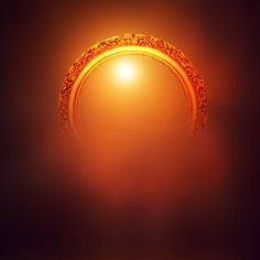 an orange ring on a black background with the sun in the middle and light shining through it