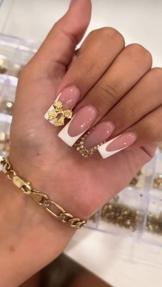 French Tip Nails Gold Accent, Gold White French Tip Nails, French Tip Acrylic Nails With Bow, White And Gold Nails With Designs, French Tip Nails With Righnstones, Gold Baddie Nails, French Tip With Gold Design, White French With Gold, Gold Bow Nails