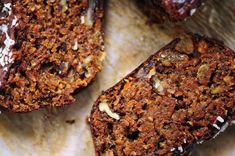 three pieces of chocolate cake sitting on top of a piece of parchment paper