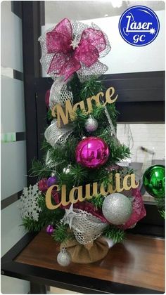 a decorated christmas tree with pink and silver ornaments