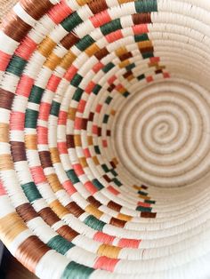 a close up view of a basket with many different colors in the bottom and sides