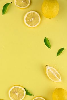 lemons and lime leaves on a yellow background