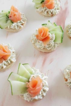 small crackers with cucumbers and salmon on them