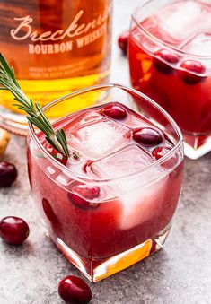 two glasses filled with cranberry punch and garnished with rosemary