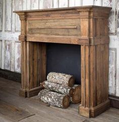 an old wooden fireplace with logs on the floor