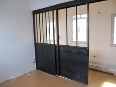 an empty room with two black doors in it