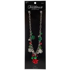 the christmas shoppe necklace is packaged in a package with chain and charms on it