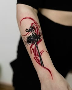 a woman with a red and black tattoo on her arm