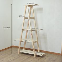 a tall wooden shelf with measurements for the top and bottom shelves in front of it