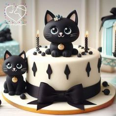 there is a cake with two cats on it and candles in the shape of cat's heads