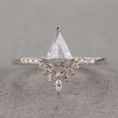 a pear shaped diamond engagement ring with side stones