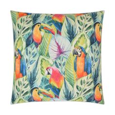 a pillow with colorful parrots and tropical leaves on the front, along with a large green leafy background